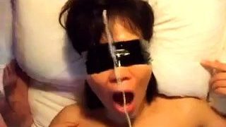 Blindfolded Asian slut takes a hard fucking and a hot facial