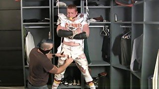 Tall redheaded football player bound gagged and stripped.