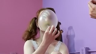 Cute girls in pigtails blowing bubbles and sharing gum