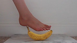 teen plays with a banana with her feet