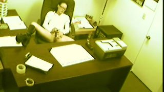 A security camera catches a lustful babe pleasing her hungry snatch in the office