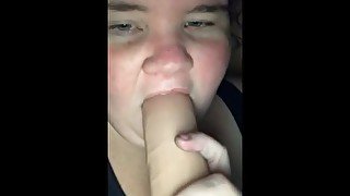 Sucking on a dildo