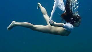 Slender and young redhead harlot in the deep blue sea