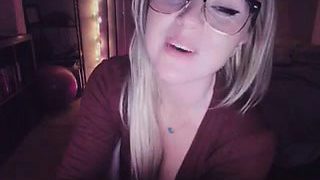 Horny blonde with glasses teases with her smoking hot breas