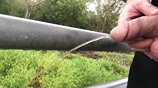 Riding the bike peeing on a bridge