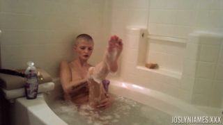 Busty whore with shaved head takes bath and sucks dick