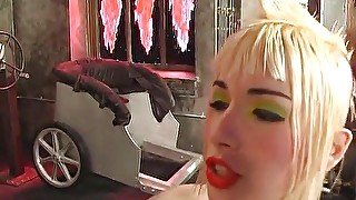 Dominatrix girls in leather dominate a guy with toys