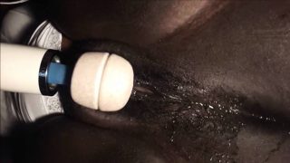 Black MILF masturbates with a vibrator.