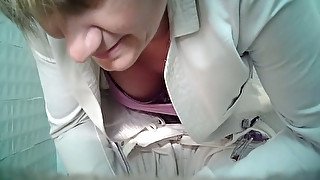 White mature blonde woman in the public restroom on voyeur video