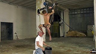 Older man tied up his male slave and strokes his stiff dick