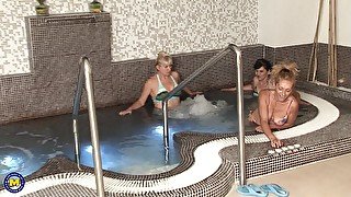 Naked mature ladies relaxing together in a sauna