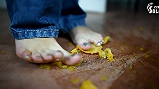 Pretty Brunette Crushing Oranges With Her Sexy Feet