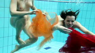 Two hotties submerged underwater