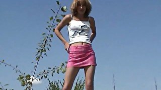 Messy haired amateur chick flashes her sexy thighs as she pisses outdoors