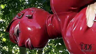 Latex Lucy in latex suit is fingering cunt