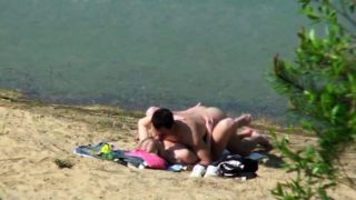 Beach voyeur spies on a young couple having passionate sex