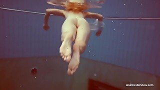 In The Indoor Pool, A Stunning Girl Swims