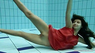 Slender teen goes swimming in her red dress