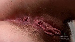 Beryl moisturizers her hairy legs, pits, tits, and pussy then plays with her tits