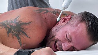 Tattooed guy loves nothing more than getting tickled by a friend