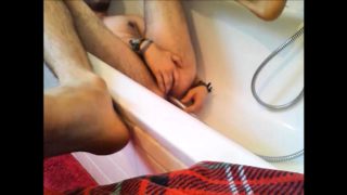 Bi-guy using shower head, squirting water, enema