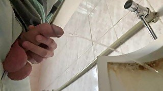 A guy pisses in a public office toilet. POV 4K