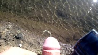 Pissing outdoor in water