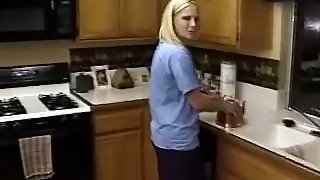 Cute blonde housewife gives her hubby blowjob in kitchen