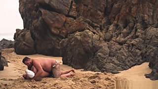 Men Wrestling On The Beach