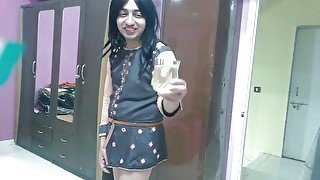 Sissy crossdresser femboy full a drinking glass with her golden water & dip her finger to taste it.