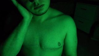 Smoking a cigarette under a green light