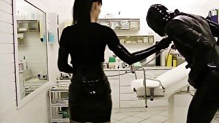 Perverted mistress is playing with tied-up gimp's cock and balls