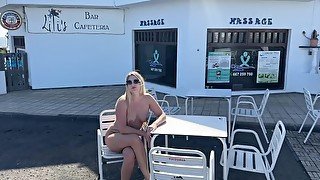 girl sitting naked in a cafe in public