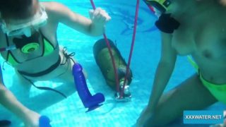 Two hot lesbians playing with dildos in the pool