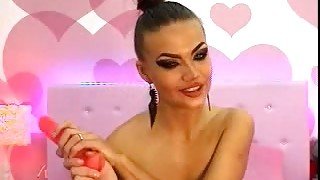 Lewd webcam whore with too heavy makeup played with sex toy