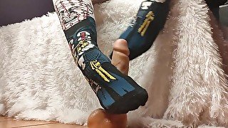 Girl in socks makes footjob on a big dildo