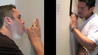 Captivating gay in t-shirt enjoying being given blowjob through gloryhole