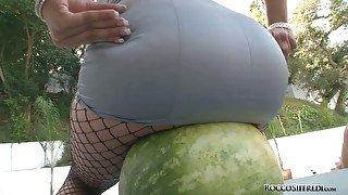 Charming brunette babe smashes watermelon with juicy ass