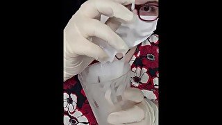 Girl plays with cum in medical gear