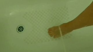 Pissing on a woman's foot and tit