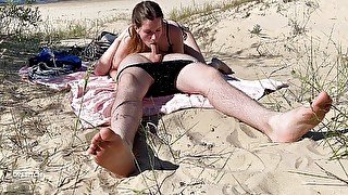 Nudist couple enjoying blowjob at the beach