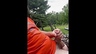 Jerking thick cock outback on the deck