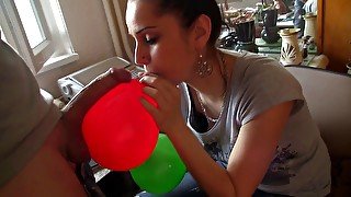 Adorable brunette licking sperm from balloon