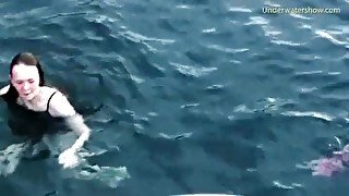 Group of girls swims naked in the ocean