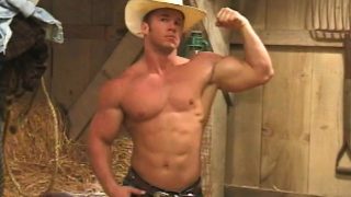 Beefy cowboy flexes and whips out his cock to give it a few strokes