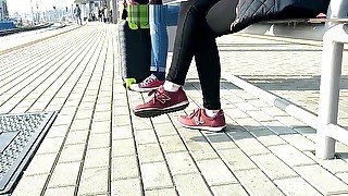 Candid girl wearing new balance sneakers waiting for a tain