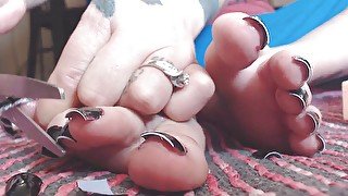 Cutting off long fake black toe nails