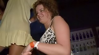 Curly-haired skank flashes her natural tits at a party