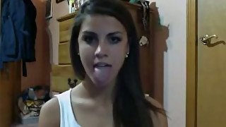 Hypnotically sexy teen is proudly showing off her long tongue