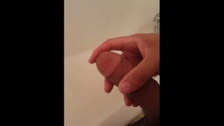 Stroking dick over the bathroom tub